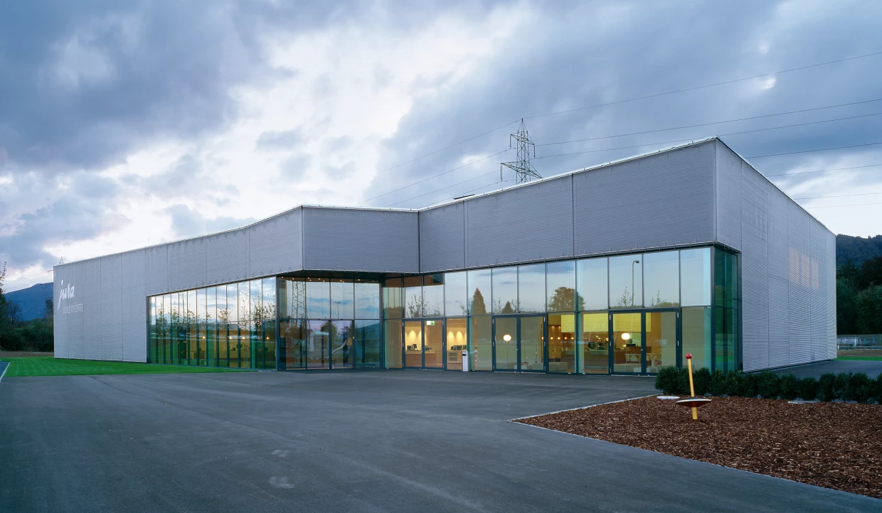 Building complex with glass fronts under a cloudy sky