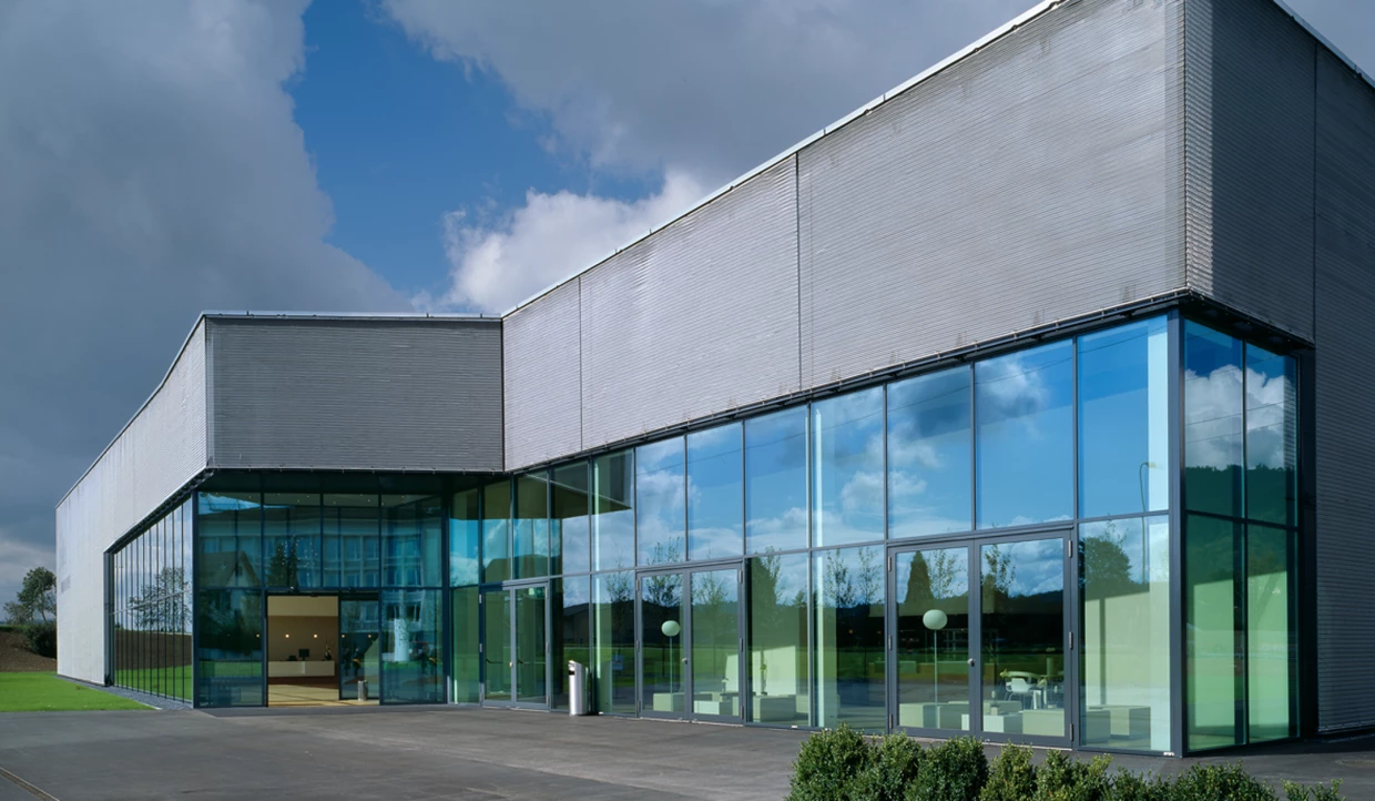 Modern building with glass facade and cloudy sky