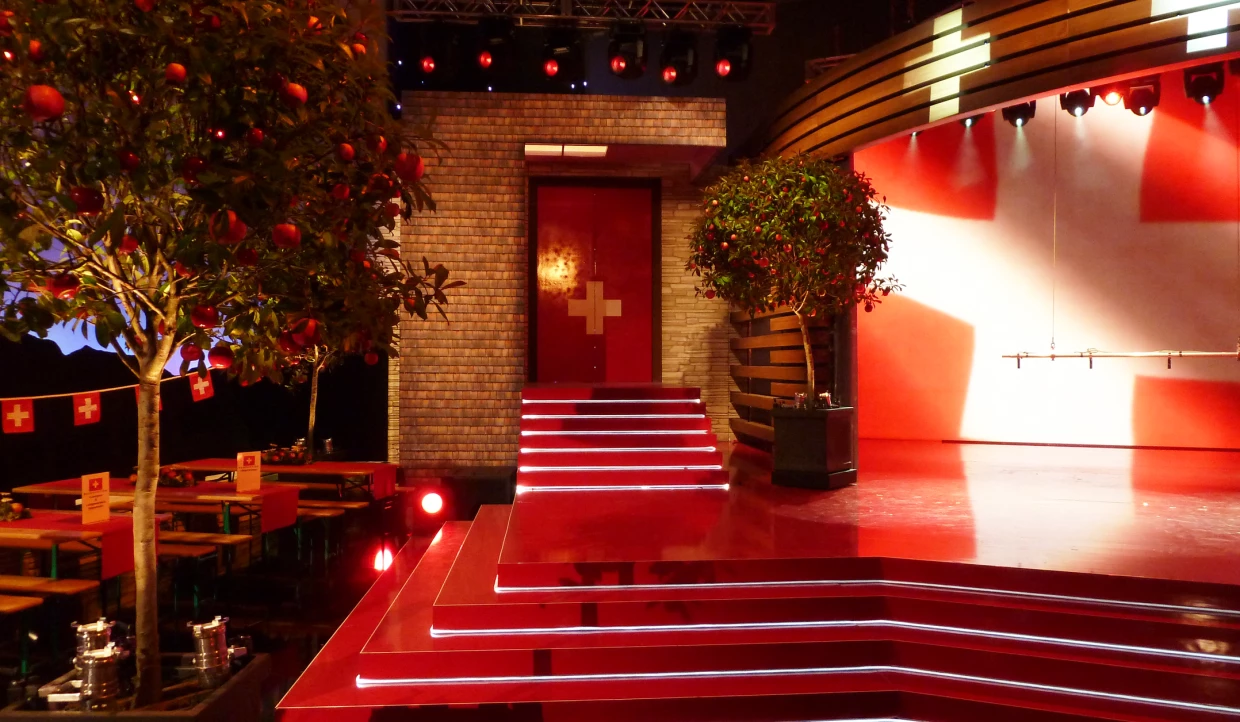 Stage with stairs, red carpet, and trees