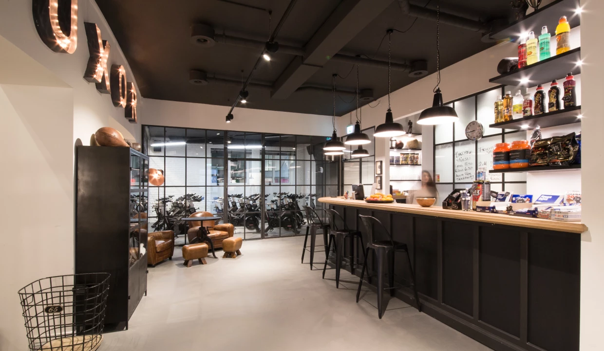 Bar counter in gym with shelves and lighting