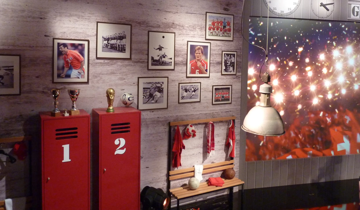 Red lockers with trophies and soccer photos on the wall