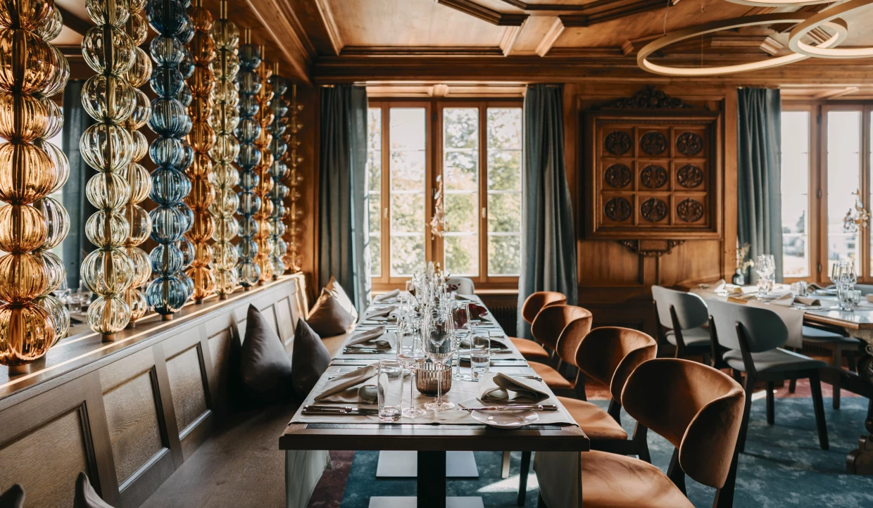 Dining area with set tables and colorful glass chains