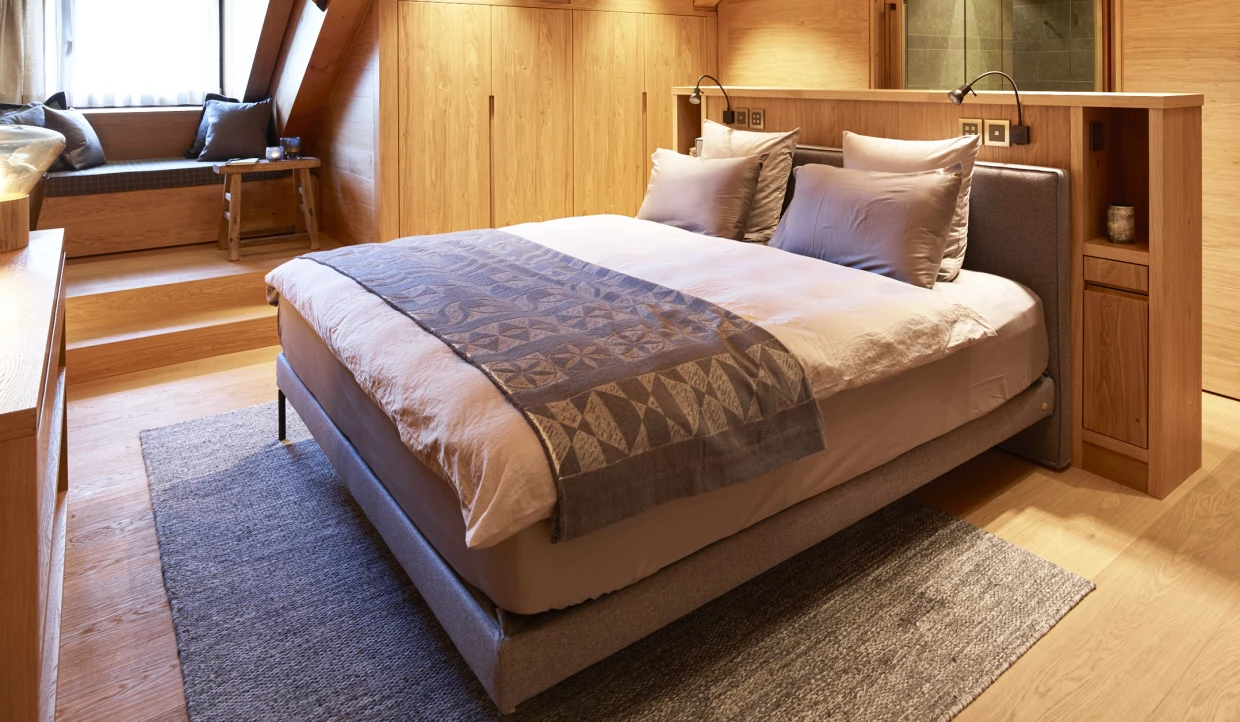 Cozy bedroom with window and wood paneling