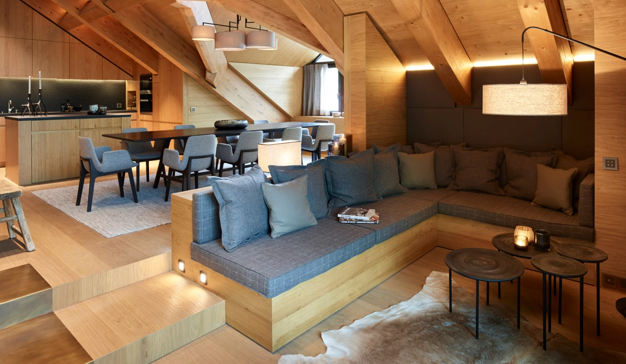 Open living area with sofa, table and kitchen